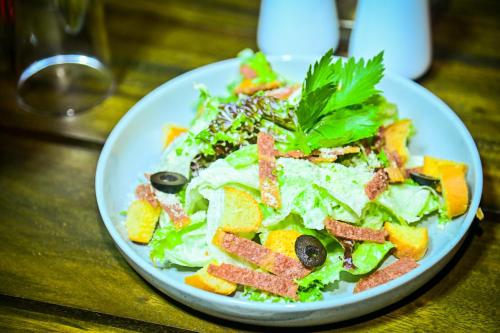 a plate of salad on a wooden table at New Sea Villa in Negombo
