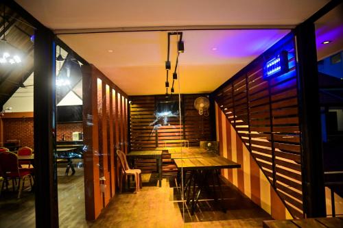 a dining room with a wooden table and a staircase at New Sea Villa in Negombo
