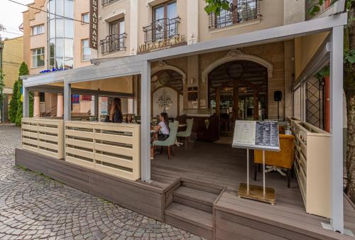 un edificio con un quiosco en una acera en Villa Boutique Hotel en Mukacheve