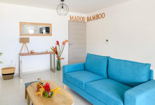 un divano blu in soggiorno con tavolo di MadouBamboo a Ducos