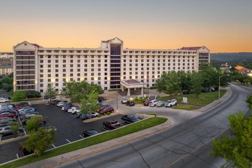 a large building with cars parked in a parking lot at Thousand Hills Resort Hotel in Branson