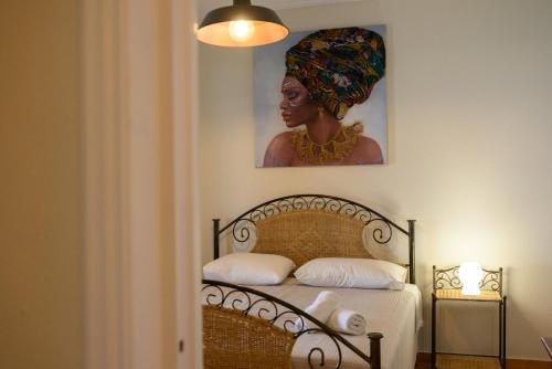 a bedroom with a bed with a painting on the wall at Seaduced Beachfront Villa by CorfuEscapes in Glyfada