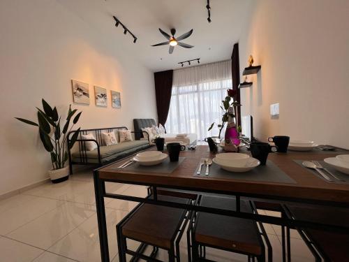 a dining room with a table and a living room at Georgetown#Amazing SkyPool#Modern & Elegant Suite# in George Town