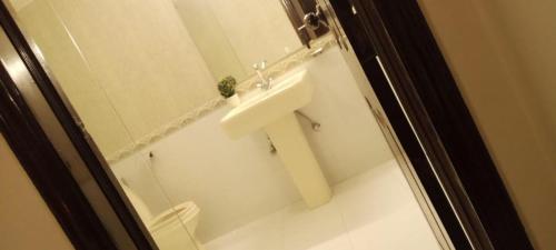 a bathroom with a sink and a mirror at Impeccable 3-Bed Apartment in Lahore in Lahore