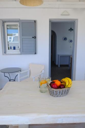 a table with a basket of fruit on it at Studio Ornos in Ornos