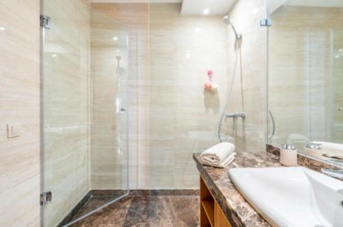 Appart 100 m2 haut standing en bord de mer في الدار البيضاء: حمام مع دش ومغسلة وحوض استحمام