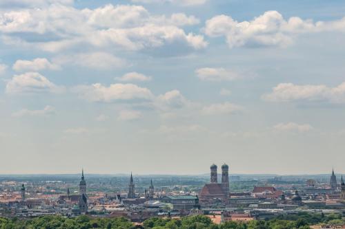 a view of a city with a cloudy sky at Four Points by Sheraton Munich Arabellapark in Munich