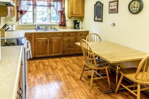 a kitchen with a table and chairs and a sink at Casual Lake Living in Union Pier