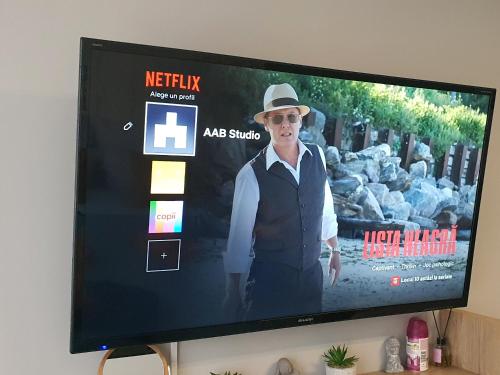 a television screen with a man in a hat on it at AAB Studio Central in Piatra Neamţ