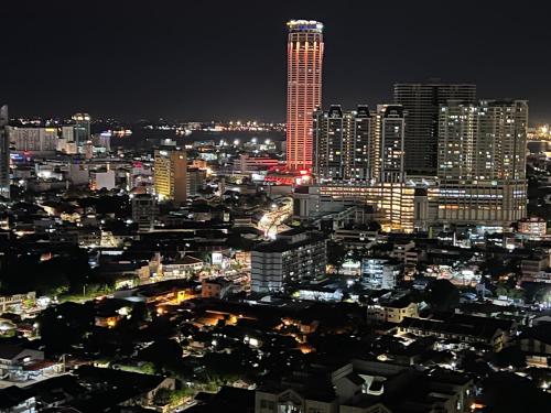 a city skyline at night with a tall building at Georgetown#Amazing SkyPool#Modern & Elegant Suite# in George Town