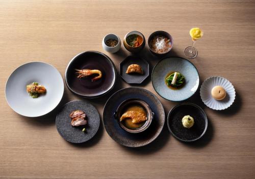 a group of plates of food on a table at Numazu Club in Numazu