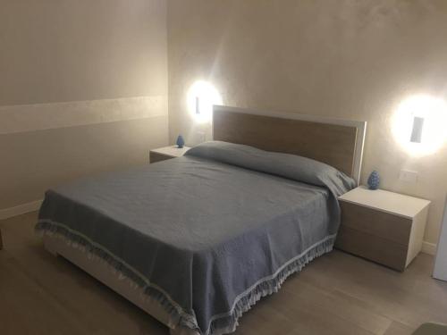a bedroom with a bed with two night stands and two lights at VILLA BORGHESE in Racalmuto