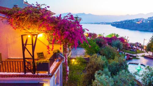 a balcony with flowers on it with a view of the water at Route Hotel Kaleici - Adult Only (12+) in Antalya