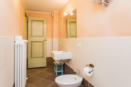 a bathroom with a sink and a toilet and a mirror at Borgo Colognola - Dimora Storica in Cenerente