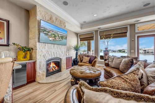 a living room with a couch and a fireplace at The Villa on Matern New Listing in Horseshoe Bay