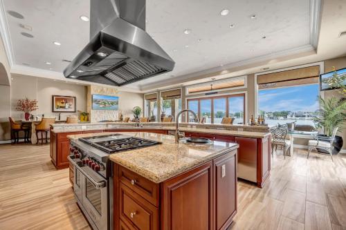 an open kitchen with a stove and a dining room at The Villa on Matern New Listing in Horseshoe Bay