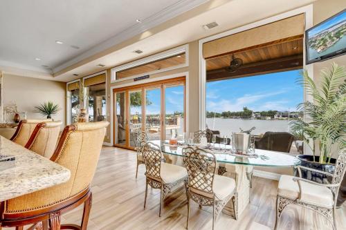 a dining room with a view of the water at The Villa on Matern New Listing in Horseshoe Bay