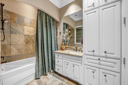 a bathroom with a tub and a sink and a shower at The Villa on Matern New Listing in Horseshoe Bay