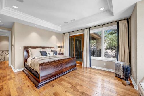 a bedroom with a bed and a large window at The Villa on Matern New Listing in Horseshoe Bay