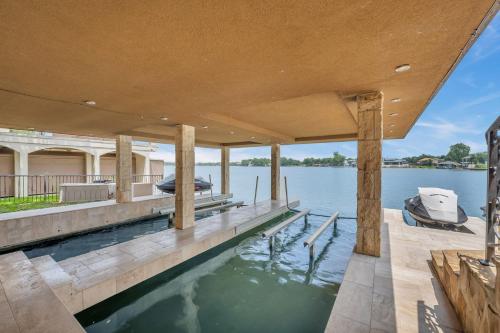 a swimming pool on a dock with a boat on the water at The Villa on Matern New Listing in Horseshoe Bay