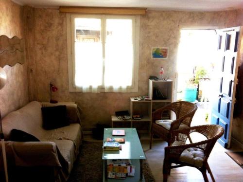 a living room with a couch and a table at Cabanon aux Goudes Marseille calanques in Marseille