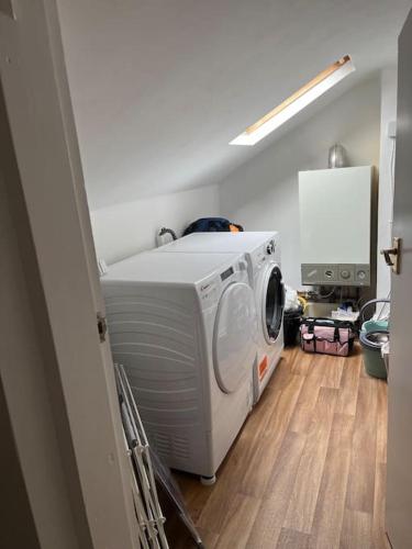 a washer and dryer sitting in a room at Cosy & Calm Escape by the Sea in Lytham St Annes