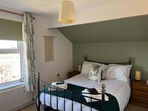 a bedroom with a bed and a window at Cosy & Calm Escape by the Sea in Lytham St Annes