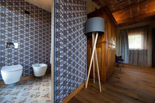 a bathroom with a toilet and a wall at Relais Casa Clara in Montaldo Roero
