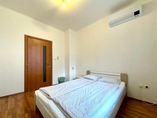 a bedroom with a large bed in a room with a door at Peaceful Place in Old Town in Bratislava