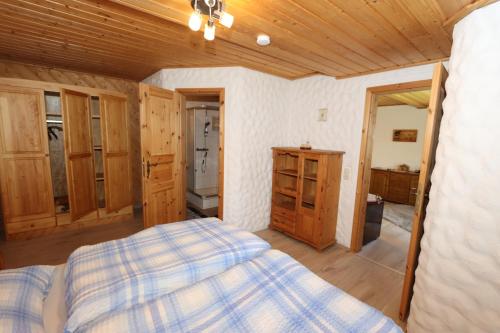 una camera con letto e soffitto in legno di Haus Andrea a Lichtenberg