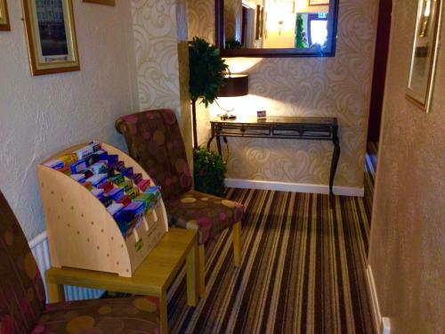 a living room with two chairs and a table at Corona Blackpool in Blackpool