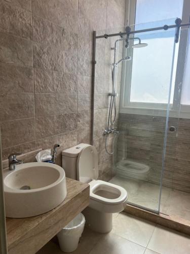 a bathroom with a toilet and a sink and a shower at Seashell villa with private pool in El Alamein