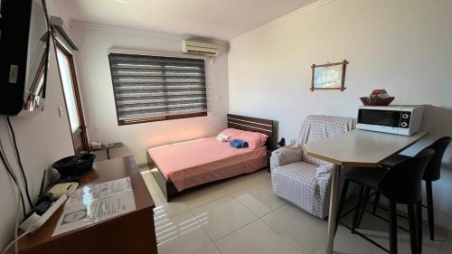 a small room with a bed and a table and a desk at Elena Court Apartments in Ayia Napa