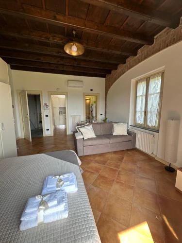 a living room with a bed and a couch at Vittoria Apartment in Serravalle Scrivia