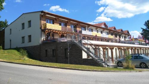 a building with a staircase on the side of it at Apartman LEO Nr. 8 Lipno nad Vltavou in Lipno nad Vltavou
