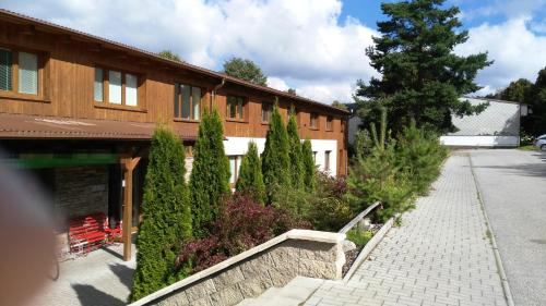 a building with a bunch of trees in front of it at Apartman LEO Nr. 8 Lipno nad Vltavou in Lipno nad Vltavou