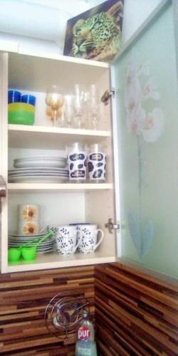 a cupboard filled with plates and bowls and dishes at Apartman LEO Nr. 8 Lipno nad Vltavou in Lipno nad Vltavou