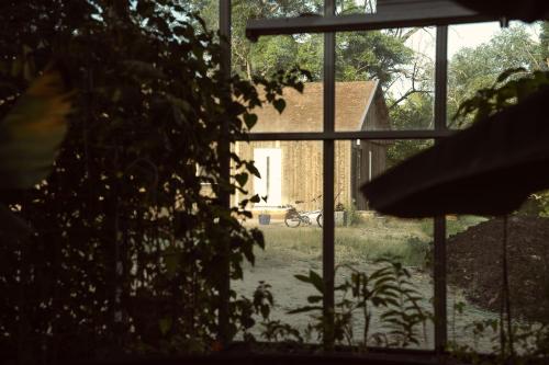 a view of a house from a window at Ödevata Gårdshotell in Emmaboda