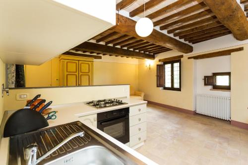 a kitchen with a sink and a stove top oven at Borgo Colognola - Dimora Storica in Cenerente