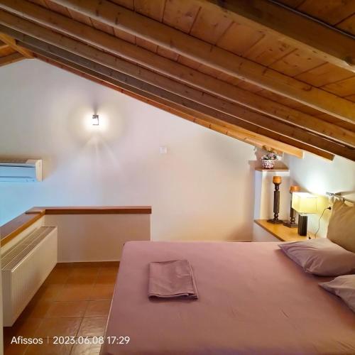 a bedroom with a large bed in an attic at Villas On The Rock Afissos in Afissos