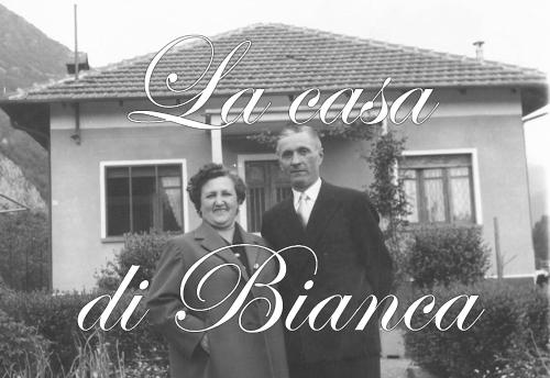 a black and white photo of two men standing in front of a house at La Casa di Bianca in SantʼAmbrogio di Torino