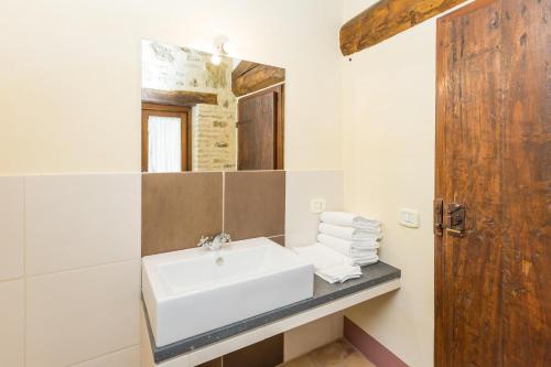 a bathroom with a sink and a mirror at Borgo Colognola - Dimora Storica in Cenerente