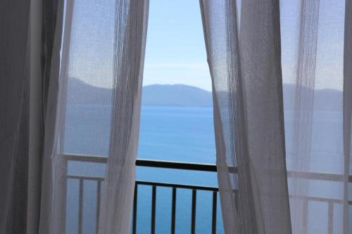 a room with a window with a view of the ocean at Galeb Bed and Breakfast in Baćina
