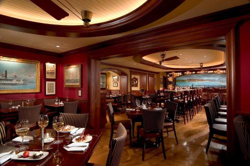 a restaurant with tables and chairs in a room at The Griswold Inn in Essex