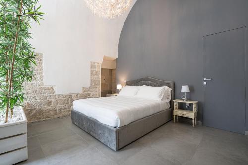 a bedroom with a bed and a table with a night stand at 2 Love rooms in Corato