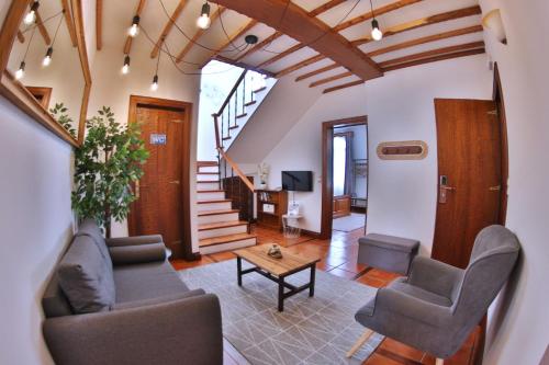 a living room with a couch and chairs and a table at Apartamentos Francisco Martins in Vila Franca do Campo