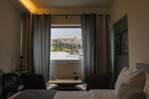 a hotel room with a window with a view of the city at Elite Ermou Suites in Athens