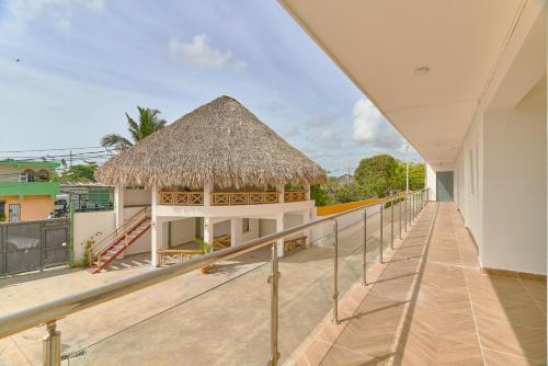 a view from the balcony of a building with a thatch roof at Sun Express Hotel in Pueblo Bavaro
