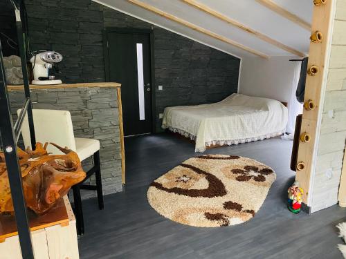 a bedroom with a bed and a rug in a room at “ Casa SARYL “ Târgu Ocna in Tîrgu Ocna