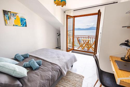 a bedroom with a bed and a view of the ocean at Lux Gradac in Gradac